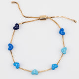 Gold chain bracelet with blue enamel hearts from Kaleidoscope Living.