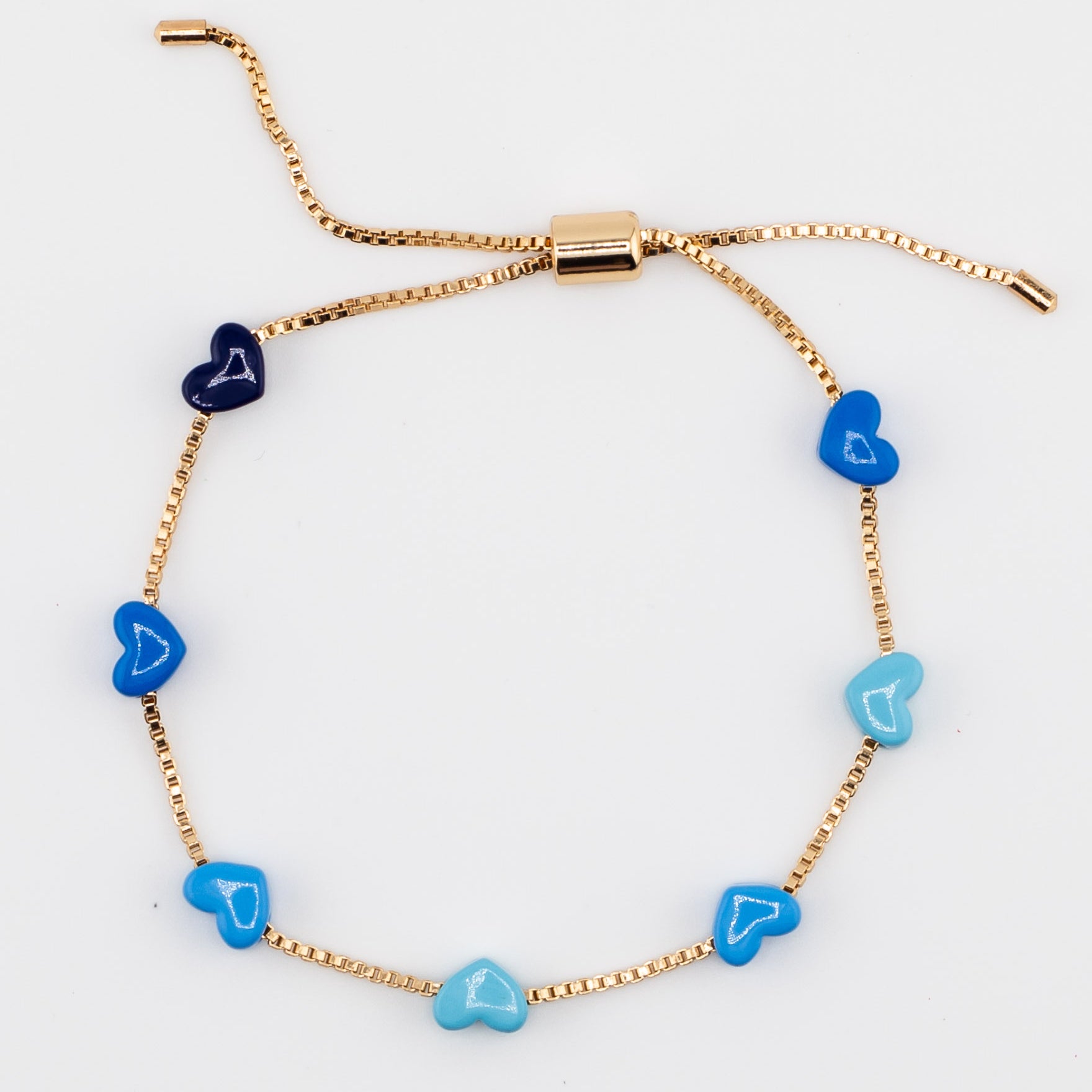 Gold chain bracelet with blue enamel hearts from Kaleidoscope Living.