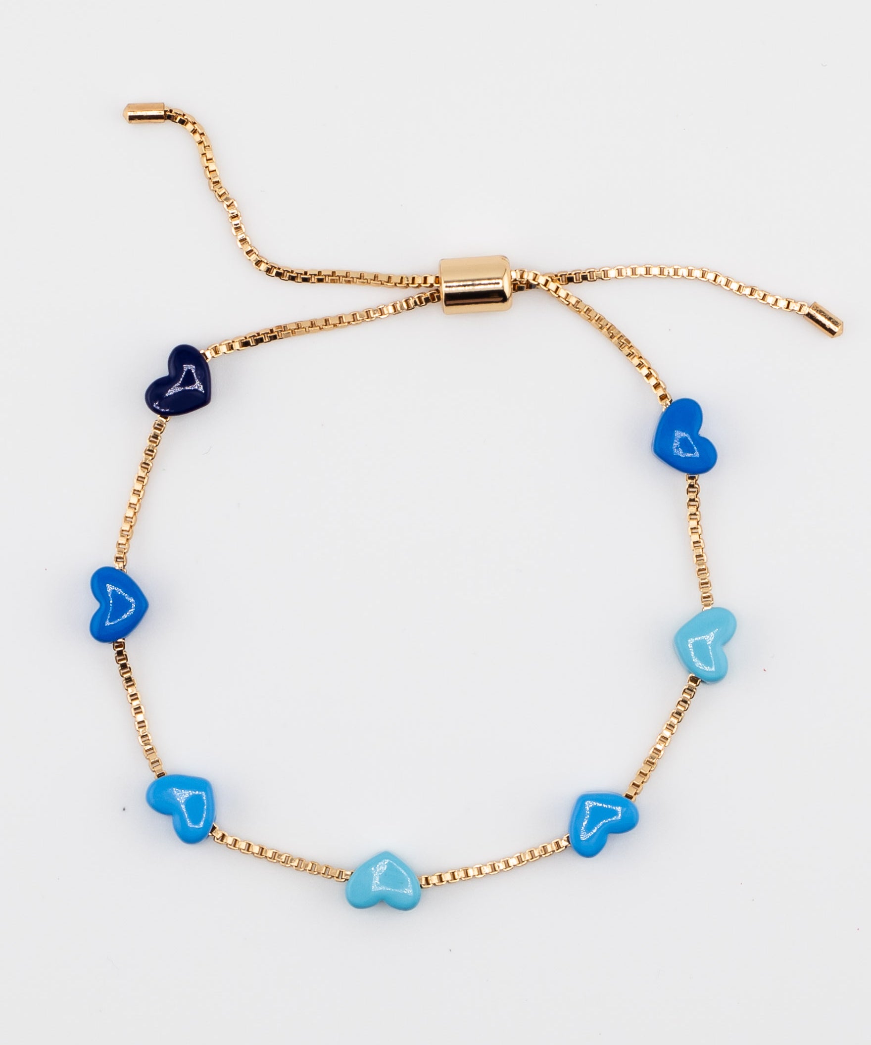 Gold chain bracelet with blue enamel hearts from Kaleidoscope Living.