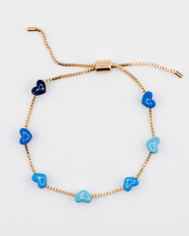 Gold chain bracelet with blue enamel hearts from Kaleidoscope Living.