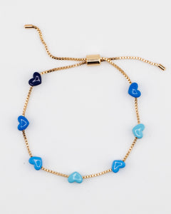 Gold chain bracelet with blue enamel hearts from Kaleidoscope Living.