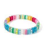 A bold, multicolor resin tile beaded bracelet featuring bright candy-like hues and gold accents.