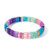 A pastel-toned resin tile stretch bracelet in pinks, purples, teals, and gold accents.