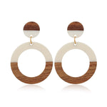 Round drop earrings made of wood and ivory-toned acrylic resin by Kaleidoscope Living