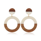 Round drop earrings made of wood and ivory-toned acrylic resin by Kaleidoscope Living