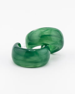 Pair of green acrylic hoop earrings with a plain white background.