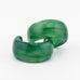 Pair of green acrylic hoop earrings with a plain white background.