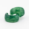 Pair of green acrylic hoop earrings with a plain white background.