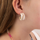 Close-up of girl wearing a creamy acrylic earring by Kaleidoscope Living