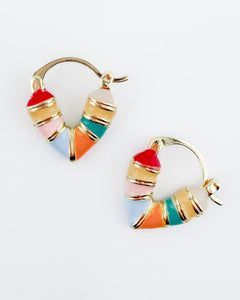 Gold heart-shaped huggie hoop earrings with multicolor enamel detailing in shades of pink, blue, orange, yellow and teal.