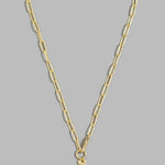 A gold paperclip chain necklace with a small gold cross pendant, displayed against a solid gray background.