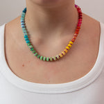 Multicolored beaded necklace in a rainbow gradient worn by a women from Kaleidoscope Living