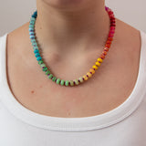 Multicolored beaded necklace in a rainbow gradient worn by a women from Kaleidoscope Living