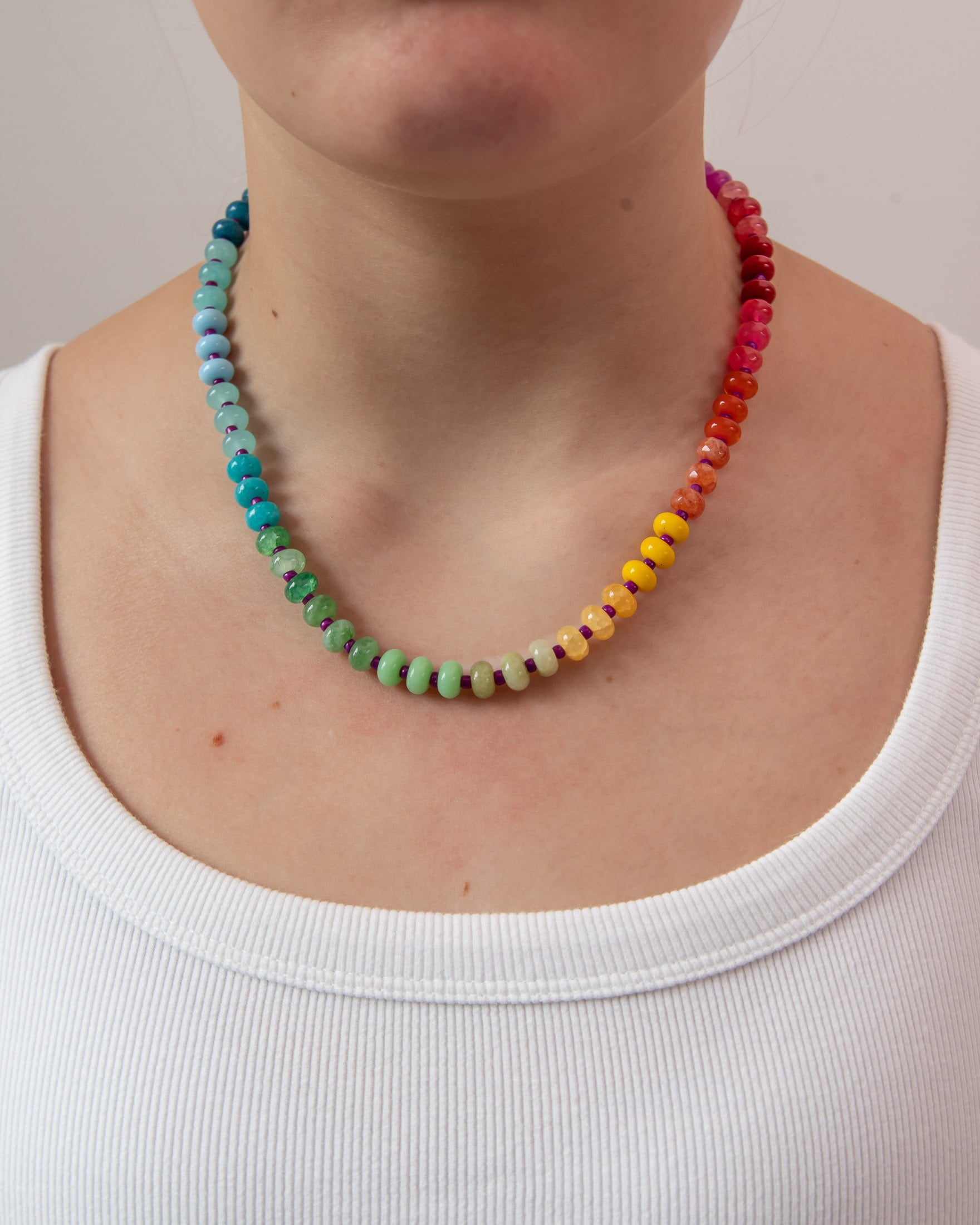 Multicolored beaded necklace in a rainbow gradient worn by a women from Kaleidoscope Living