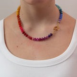 Rainbow gradient beaded necklace on a women wearing a white t-shirt showing the gold clasp to the side.