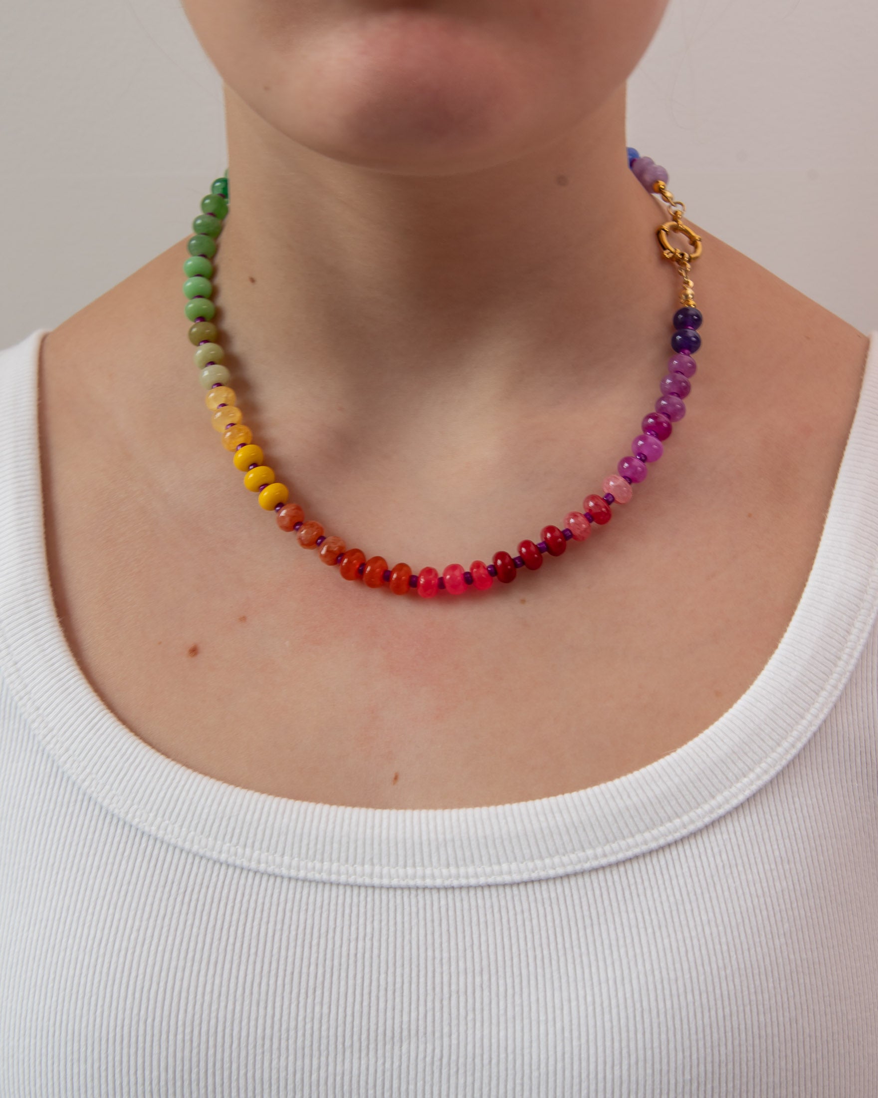 Colorful beaded necklace show on a women with a white shirt by Kaleidoscope Living