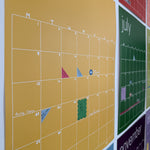 Side view of rainbow wall calendar with colorful planner and calendar stickers used to mark important appointments and events