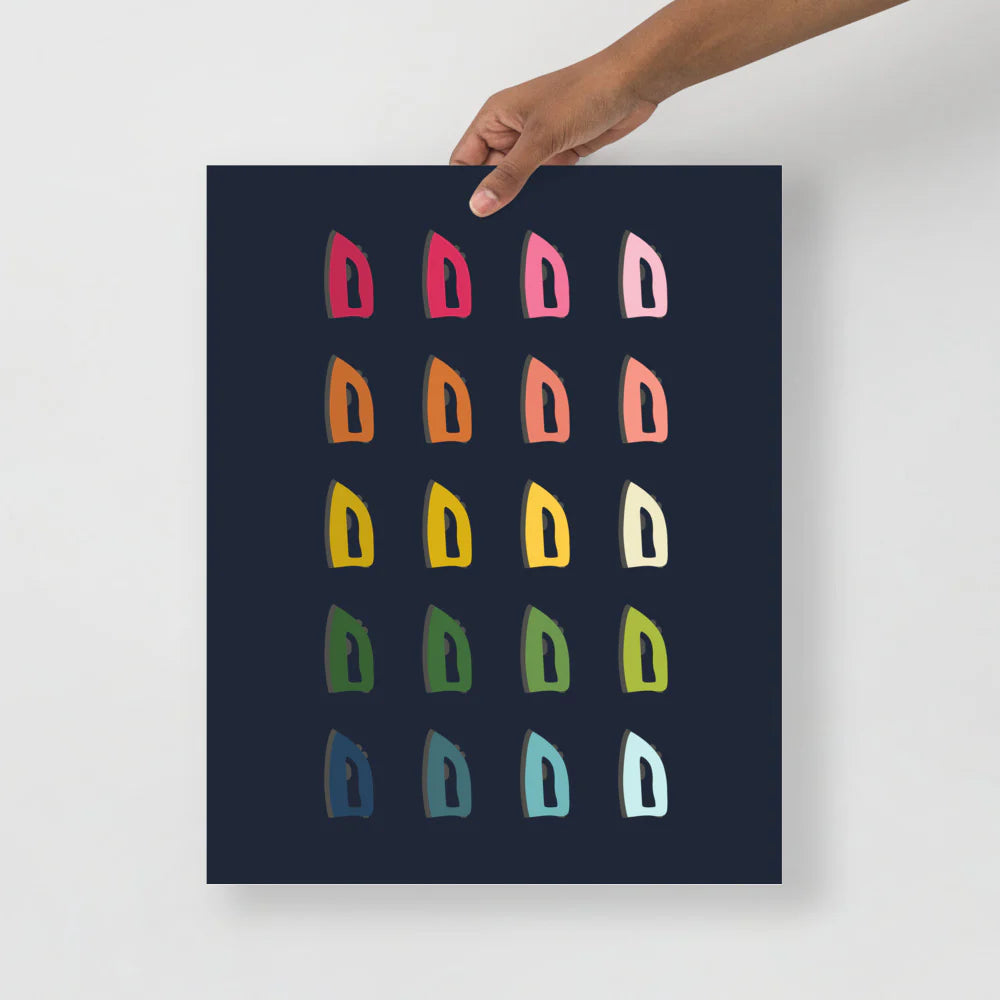 laundry room art print with a navy background and grid of colorful clip art of irons in ombre rainbow colors ranging from pinks to blues