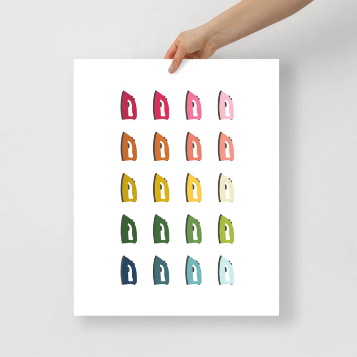 laundry room art print with a white background and grid of colorful clip art of irons in ombre rainbow colors ranging from pinks to blues