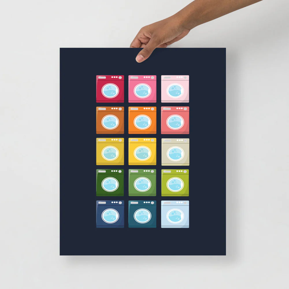 laundry room art print with a navy background and grid of colorful clip art of washing machines in ombre rainbow colors ranging from pinks to blues