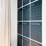 large erasable navy blue wall calendar hanging on wall from Kaleidoscope Living