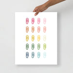 office art print with a white background and grid of colorful clip art of paperclips in ombre rainbow colors ranging from pinks to blues