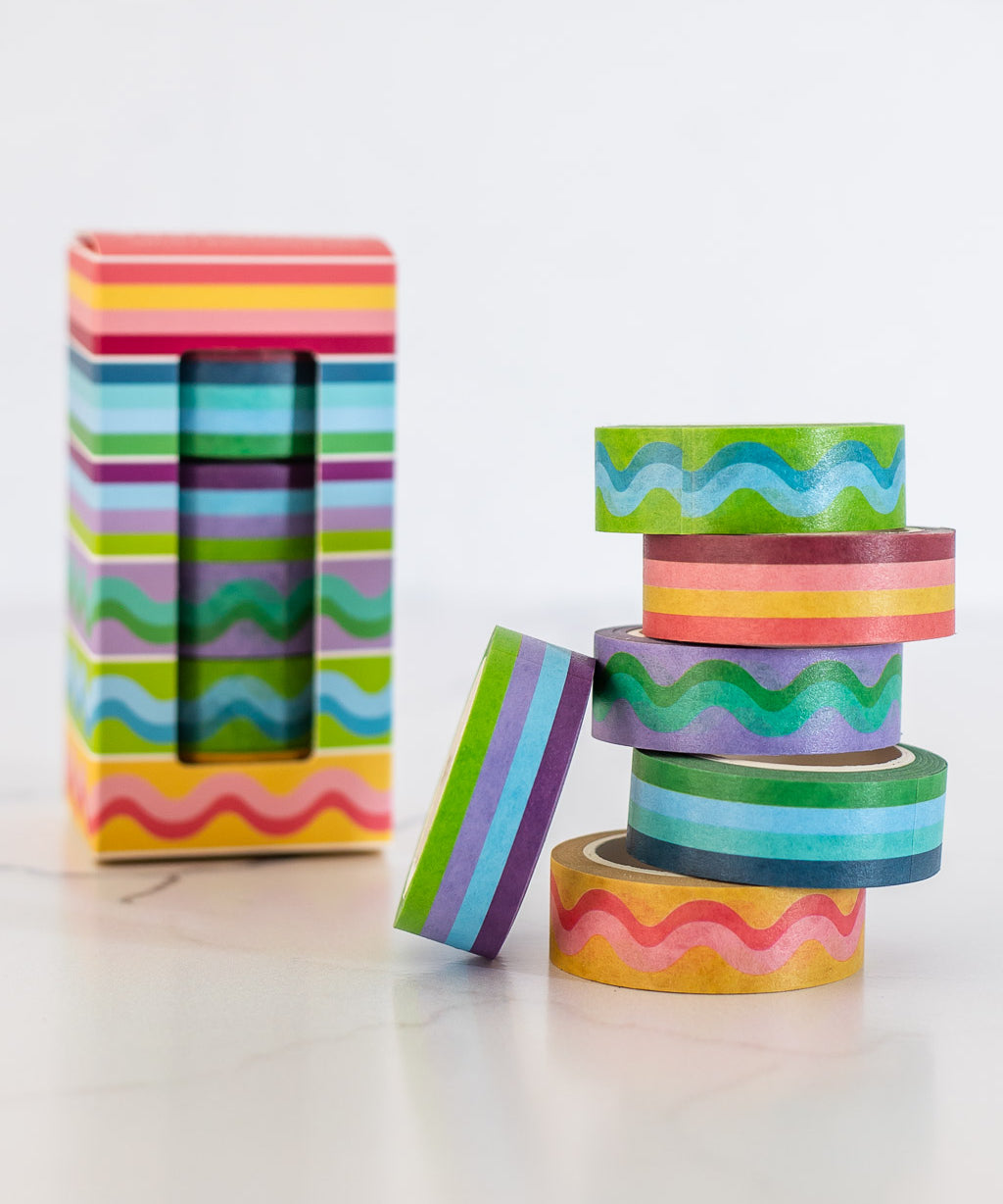 image of colorful striped and squiggle washi tape stacked in a pile with product box in background