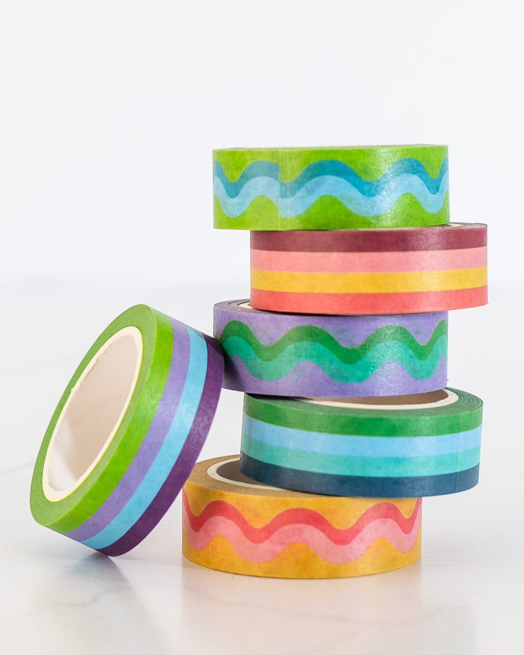 image of colorful striped and squiggle washi tape stacked in a pile
