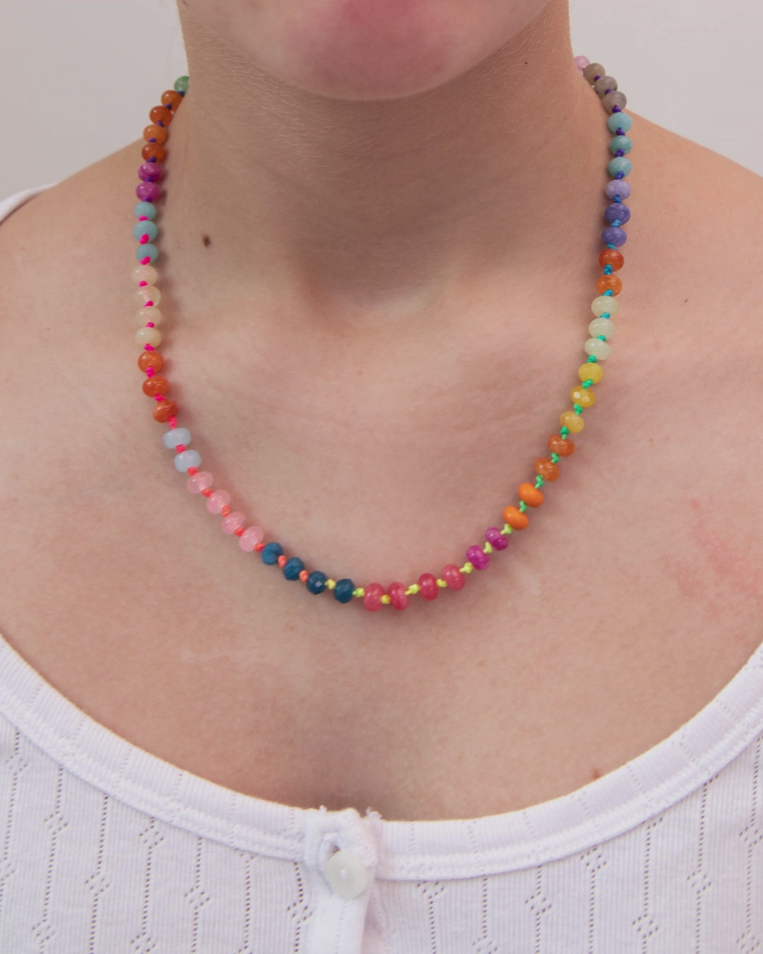 Multicolored statement necklace with round beads, neon cord and gold clasp by Kaleidoscope Living