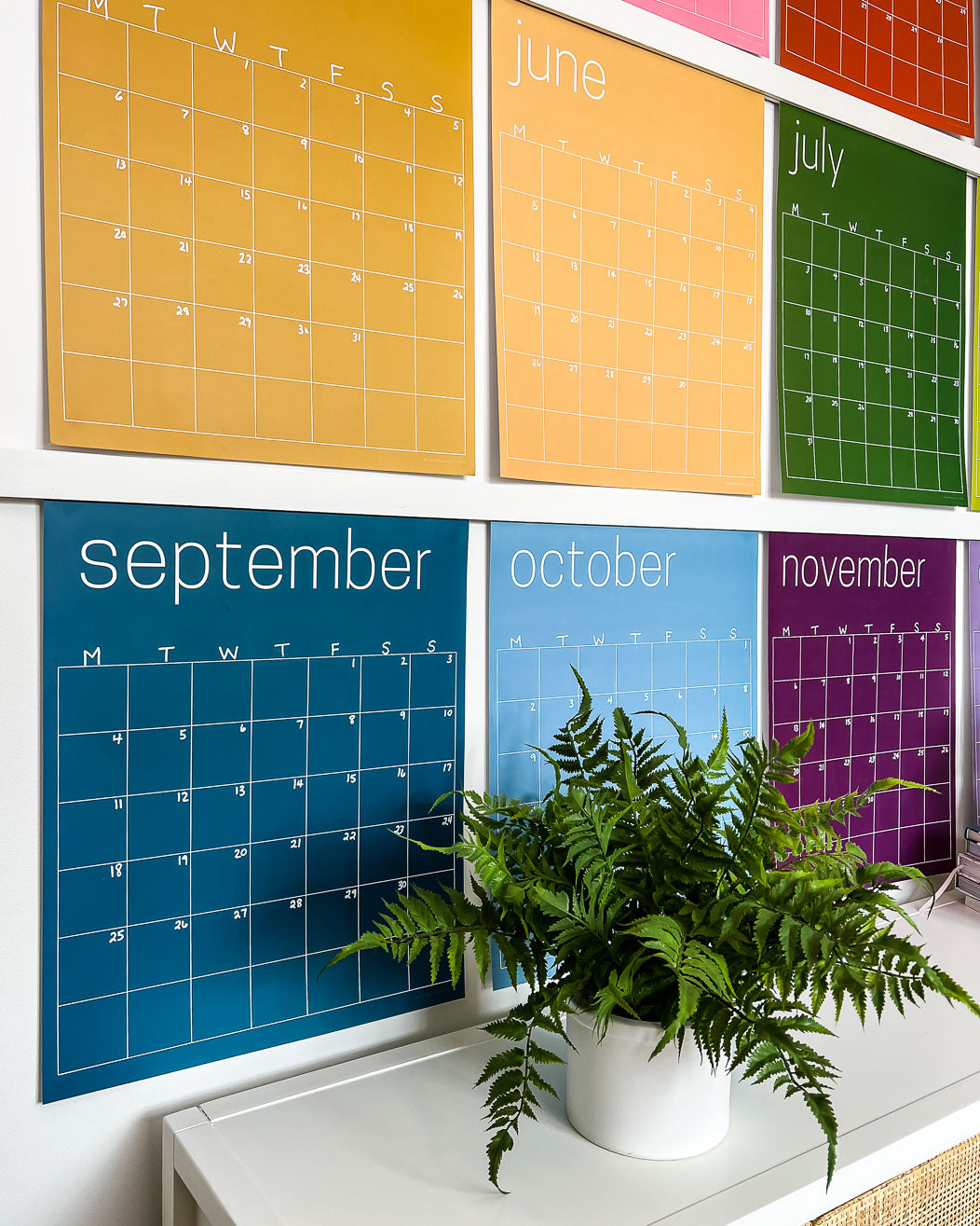 Close up of May through November pages of the large undated and reusable wall calendar in colorful rainbow hues from Kaleidoscope Living
