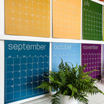 Close up of May through November pages of the large undated and reusable wall calendar in colorful rainbow hues from Kaleidoscope Living
