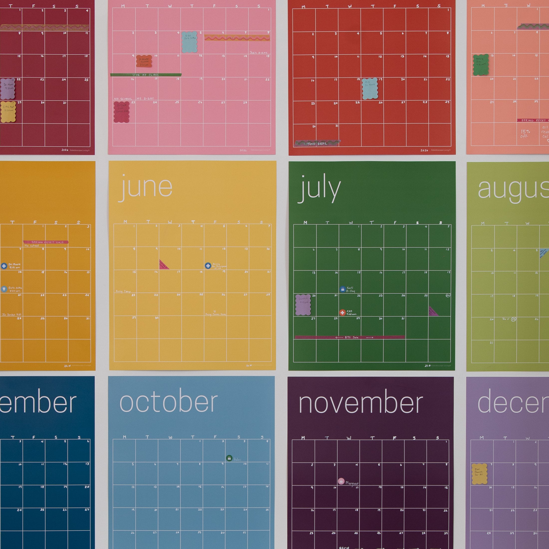 Close up picture of the kaleidoscope Living reusable rainbow wall calendar showing their washi tape and sticky notes.