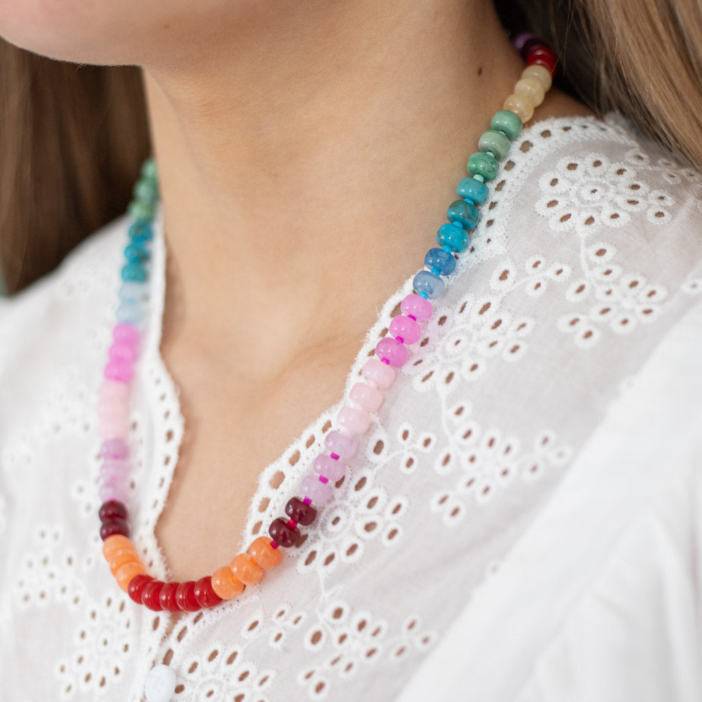 Colorful beaded necklace with color changing cord in warm rainbow hues