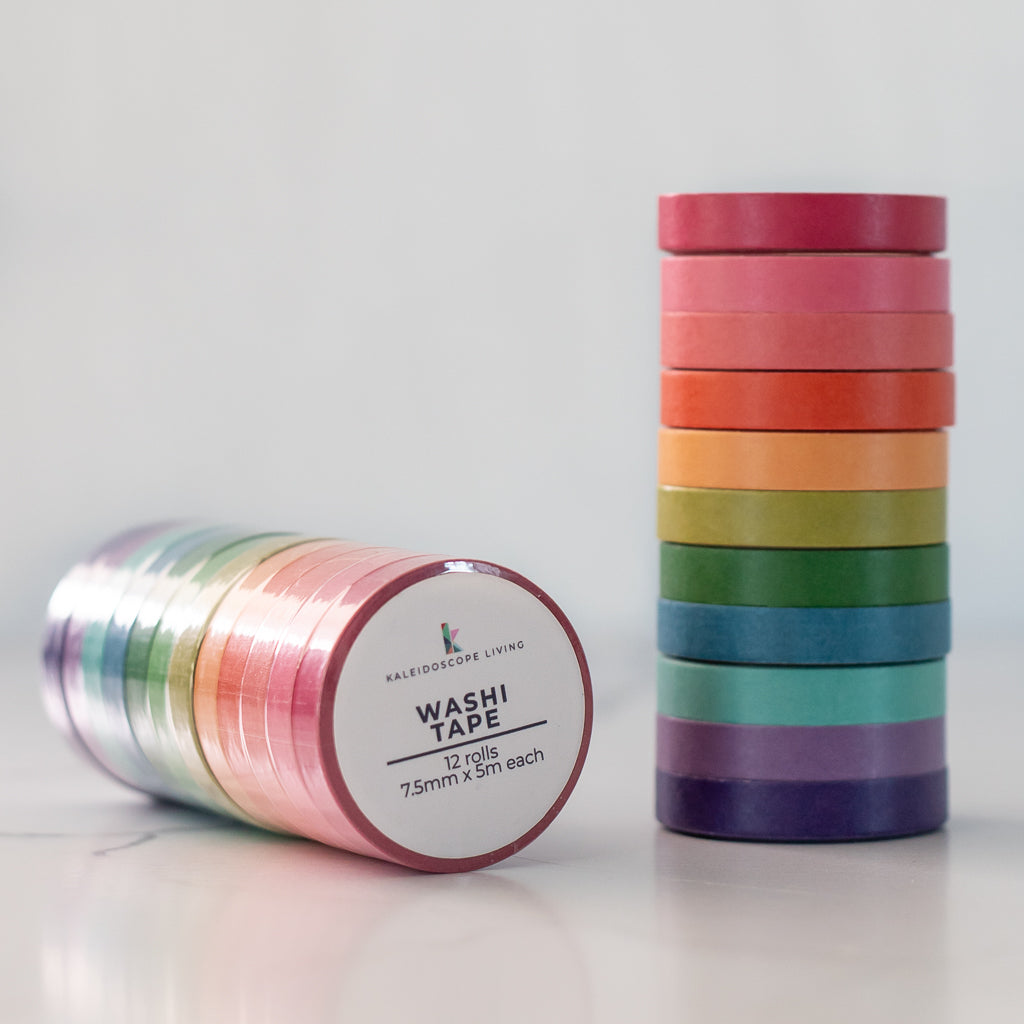 Stack of 12 colorful washi tape rolls on a light background from Kaleidoscope Living