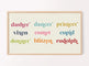 A digital artwork displayed on a television, featuring the names of reindeer in colorful typography and cream  background, hanging on a wall.